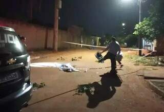 Corpo da vítima coberto por lençol no meio da rua. (Foto: Direto das Ruas) 