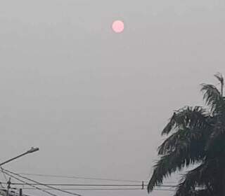 Às 7h de ontem, o Sol vermelho ainda era visto no céu de Campo Grande (Foto: Silvia Frias)