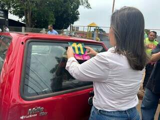 Adriane adesiva carros durante agenda desta sexta-feira (Foto: Fernada Palheta)