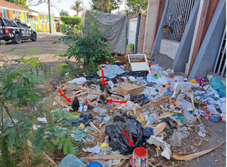 Barraco e monta de lixo na calçada do homem; setas apontam fezes humanas e de animais (Foto: Reprodução)