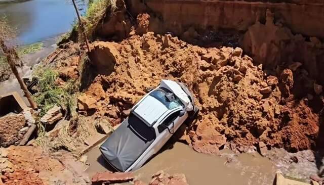 Motorista ignora aviso e cai com picape em cratera de estrada rural