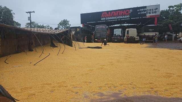 Carreta tomba em manobra e espalha 50 toneladas de milho em p&aacute;tio de oficina