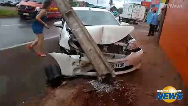 Acidente entre dois carros termina com motorista ferida e poste quebrado